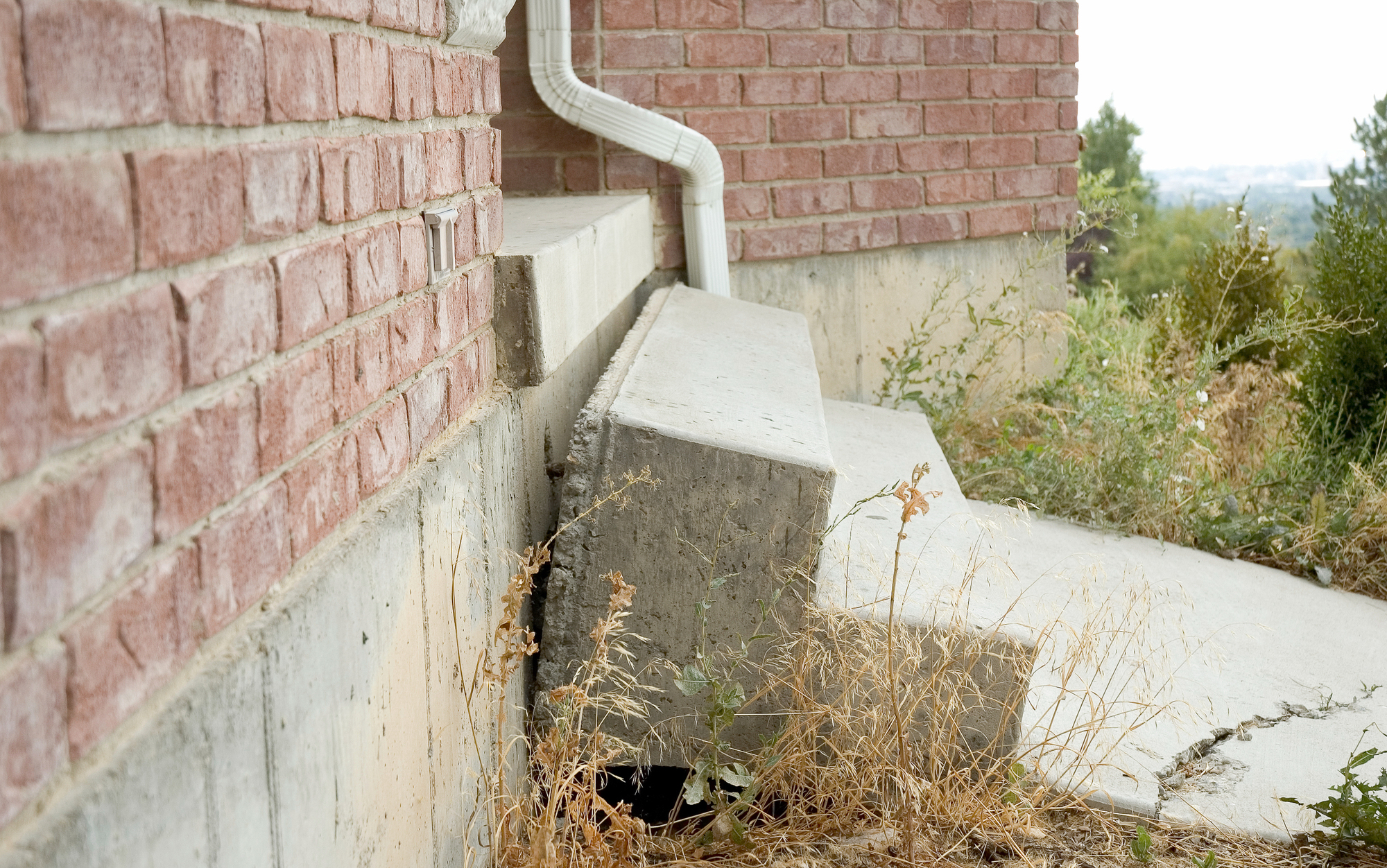 Concrete Stairs falling away from home due to earth settling