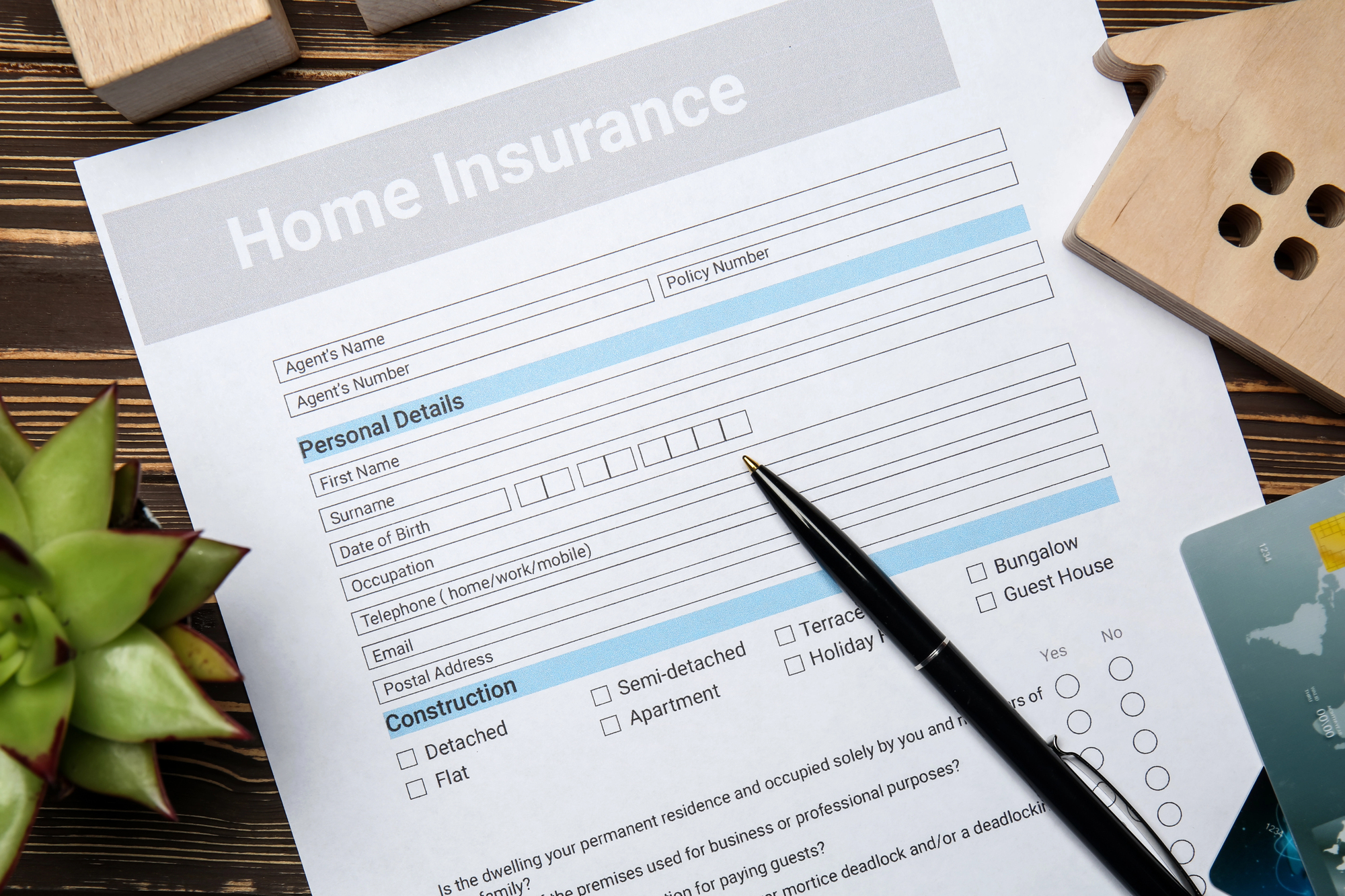 Home insurance form on wooden table