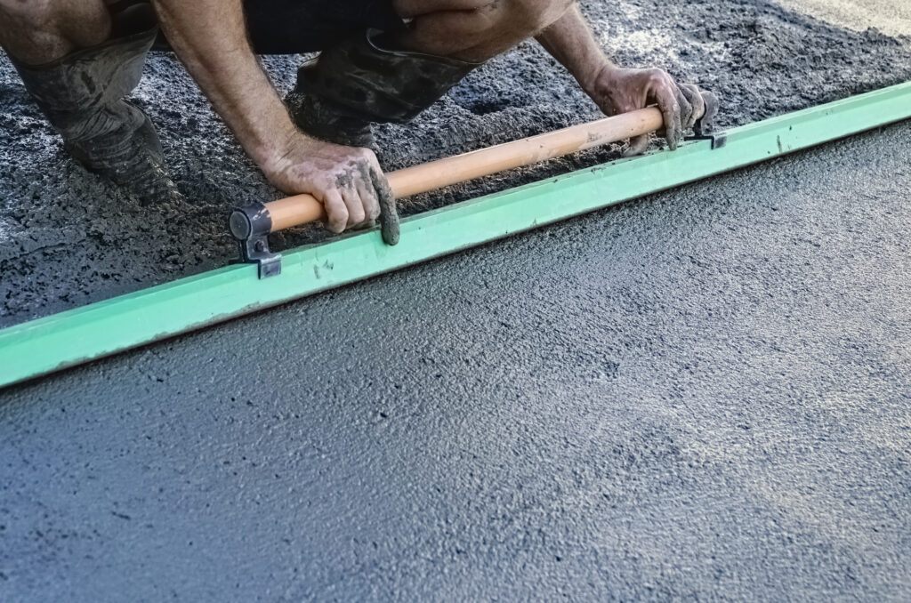 One man at work using a float for concreting a drive way