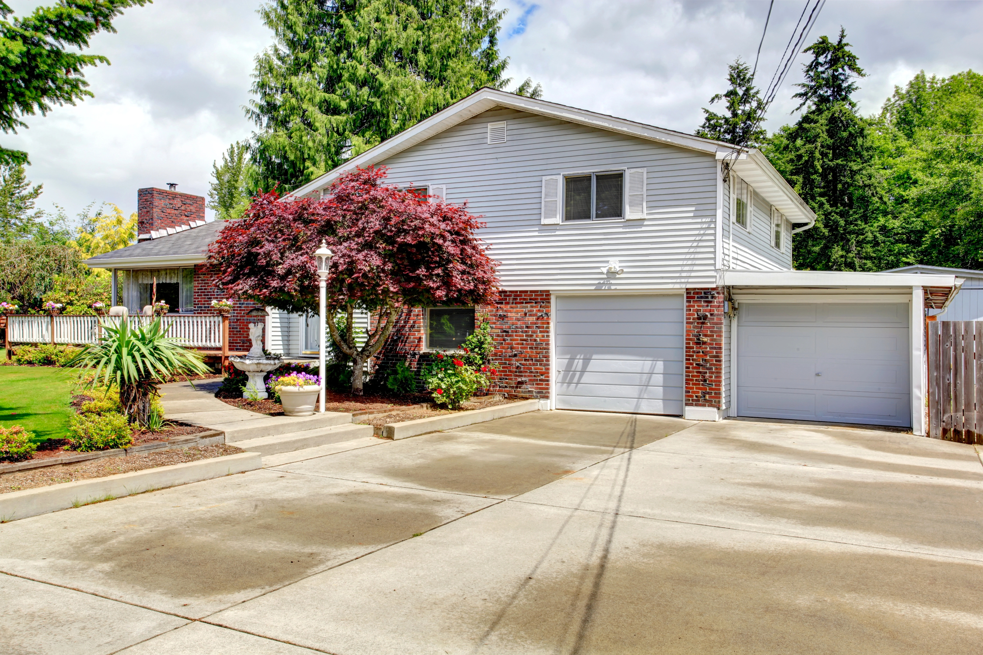 House exterior with brick wall trim and concrete driveway