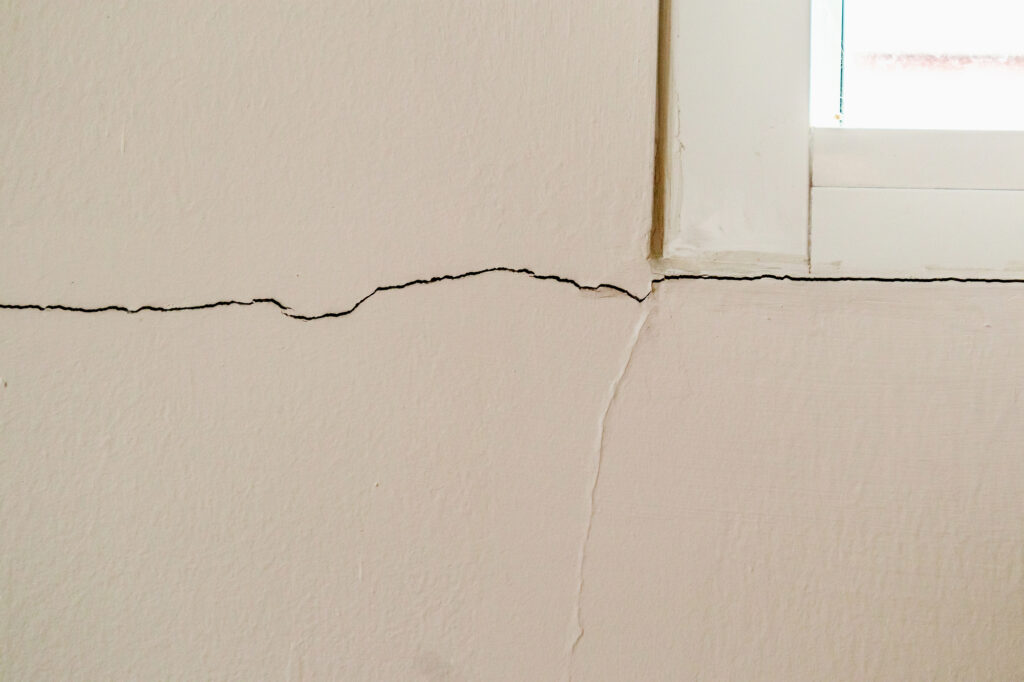 New house wall crack near window frame